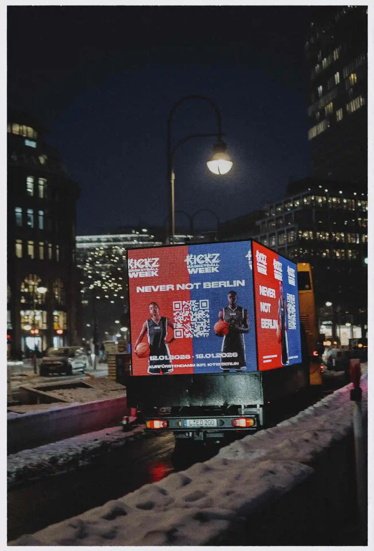 LED truck with digital basketball advertising for Kickz Week in Berlin at night.